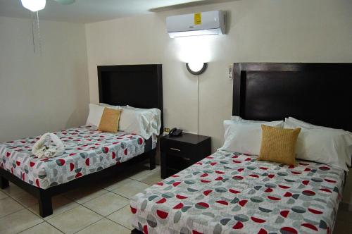 a hotel room with two beds at Hotel del Alba Inn & Suites in Aguascalientes