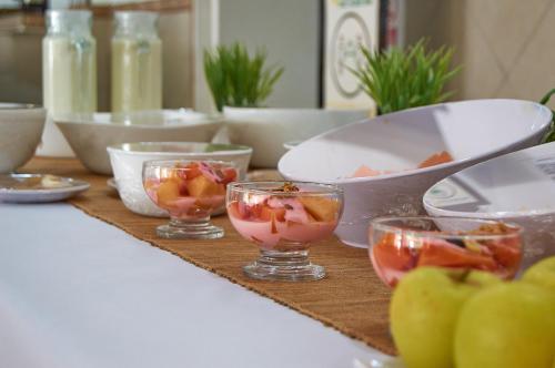 a table with bowls and bowls of food on it at Hotel del Alba Inn & Suites in Aguascalientes