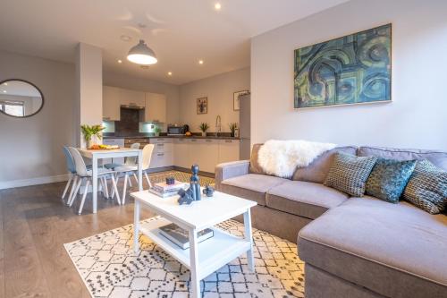 a living room with a couch and a table at Church View, Geneva House in Peterborough