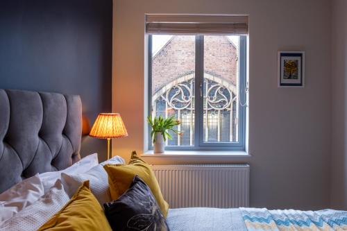 a bedroom with a bed and a window at Church View, Geneva House in Peterborough