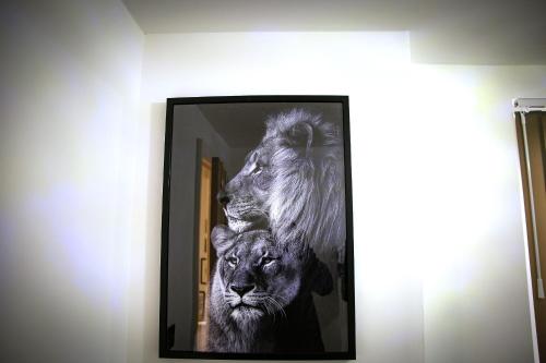 a framed picture of two lions and a lion at Rostron House in Manchester