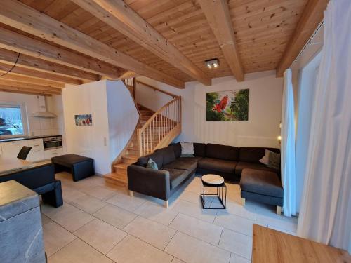 a living room with a couch and a staircase at Chalet in Kötschach by Ski Slopes in Kötschach