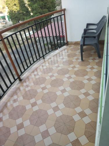 a balcony with a chair and a tiled floor at ROYAL BREEZE HOTEL & RESTAURANT Received Most Rated Traveller Award Property For Year 2023-2024 !! in Mussoorie