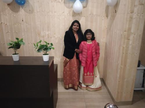 a woman and a little girl standing in a room at ROYAL BREEZE HOTEL & RESTAURANT Received Most Rated Traveller Award Property For Year 2023-2024 !! in Mussoorie