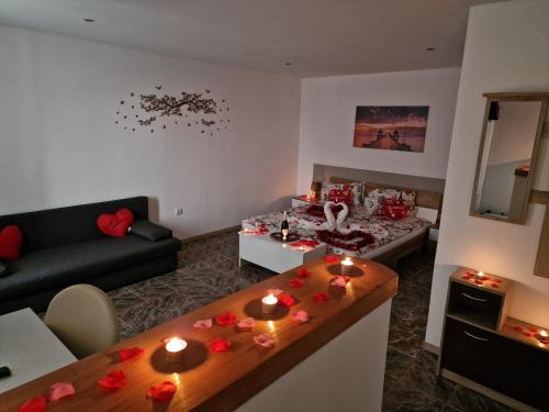 a living room with a couch and a table with candles at Pensiunea B&B Casa Italia in Timişoara