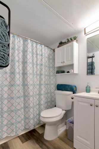 a bathroom with a toilet and a shower curtain at Beach View & SeaBreezes in Corpus Christi