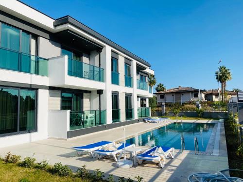 an image of a house with a swimming pool at İSTANBUL BEACH HOTEL SWEET HOME in Kemer