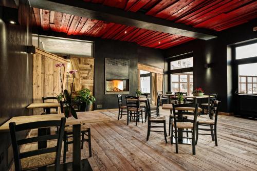 a restaurant with tables and chairs in a room at Antico Albergo Stella d'Italia in Folgaria