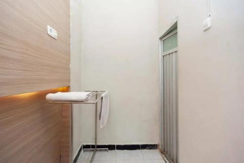 a bathroom with a towel sitting on a counter at RedDoorz at KM 5 Palembang in Palembang