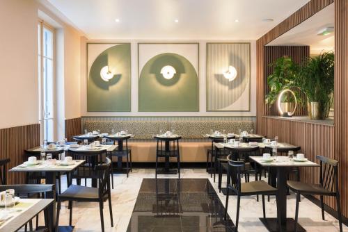 a dining room with tables and chairs at Hotel Khla Nice in Nice