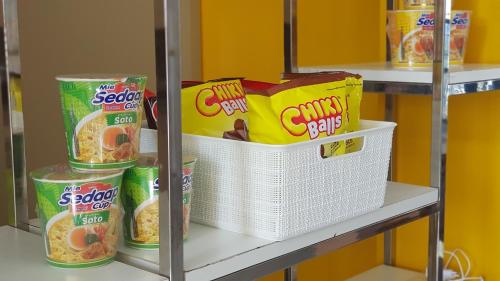 a shelf with a bunch of food in a pantry at Apollo Capsule Hotel in Ende