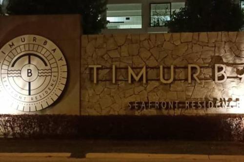 a building with a clock on the side of it at Timurbay Seafront Residence By Ozzy Azizi in Kuantan
