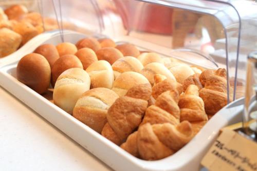 a display case filled with lots of pastries at Urban Hotel Kyoto Gojo Premium in Kyoto
