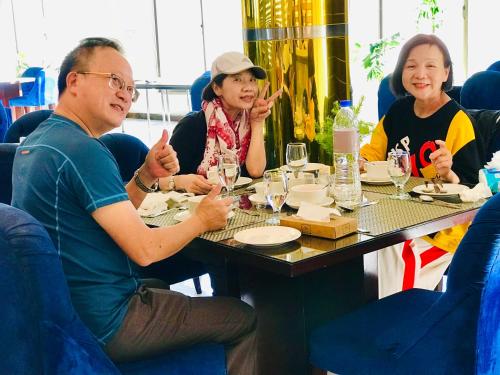 a group of people sitting around a table at Swat Palace Hotel By Northin in Mām Derai