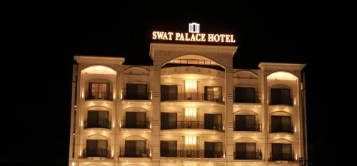 a hotel building with a sign on top of it at Swat Palace Hotel By Northin in Mām Derai