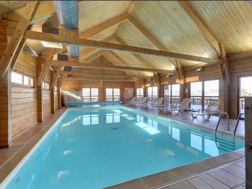 德沃吕伊Chalet confortable La Joue du Loup, piscine - FR-1-504-638的一座带木制天花板的大型室内游泳池