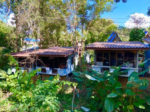 a house in the middle of a garden at Shaya Suandoi Resort in Pai