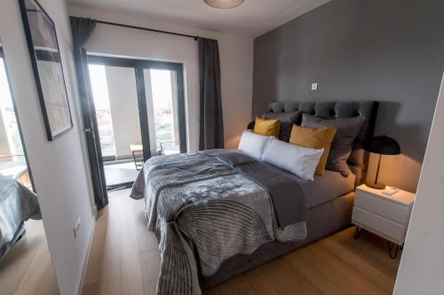 a bedroom with a bed and a large window at MAAN BZ15 Luxury Apartment in Zadar