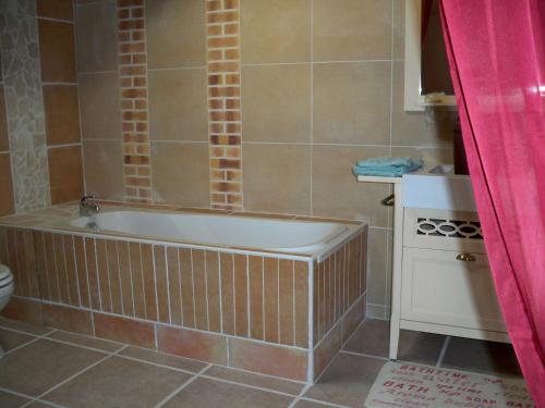 a bathroom with a tub and a sink and a toilet at Marrakech Guest Room in the heart of the vineyard in Badens