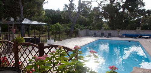 a swimming pool in a yard with a fence at Marrakech Guest Room in the heart of the vineyard in Badens