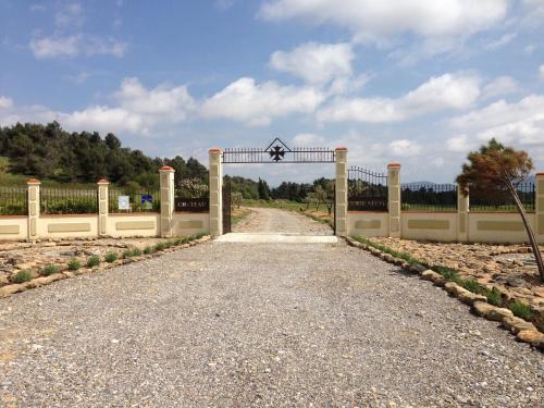 a gate to a driveway with a road at Marrakech Guest Room in the heart of the vineyard in Badens