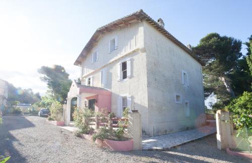 a small white building on the side of a road at Marrakech Guest Room in the heart of the vineyard in Badens