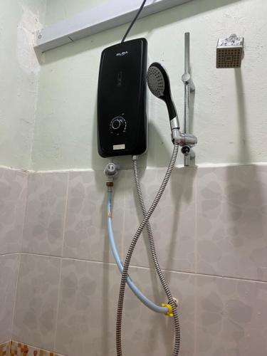 a blow dryer is attached to a wall at Raihan Beach Resort in Dungun
