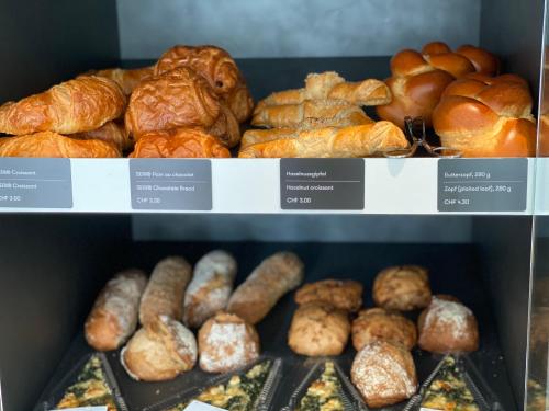a display of different types of bread and pastries at Hotel Arte Spreitenbach in Spreitenbach