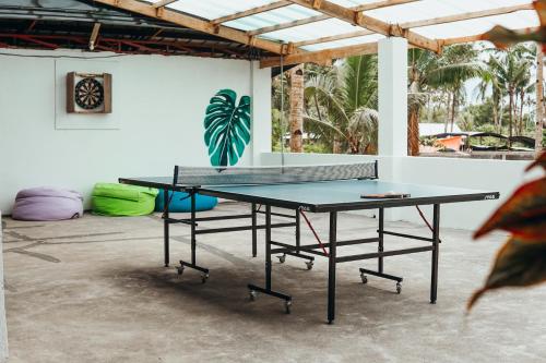a ping pong table in a room at Sunlit Hostel in General Luna