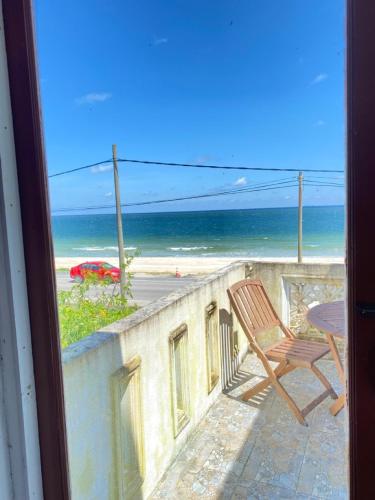 a balcony with a chair and a view of the beach at Raihan Beach Resort in Dungun