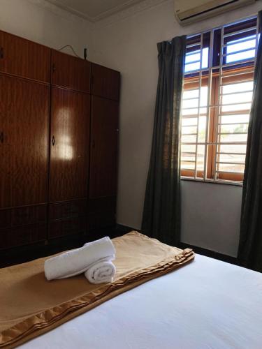 a bedroom with a bed with two towels on it at Raihan Beach Resort in Dungun