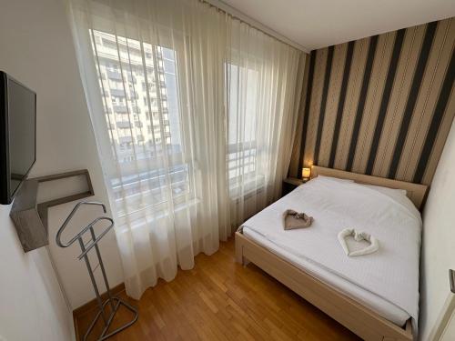 a bedroom with a bed with two towels on it at Nevena Belville Apartments in Belgrade