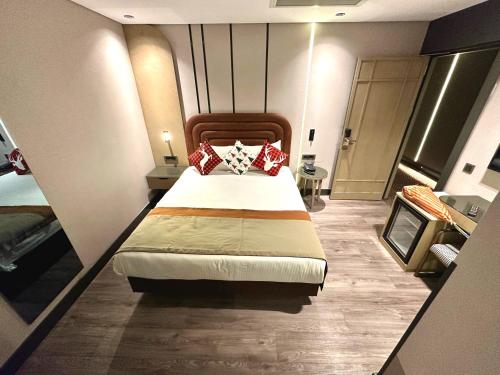 a bedroom with a bed with red pillows on it at Edition Old City Hotel in Istanbul