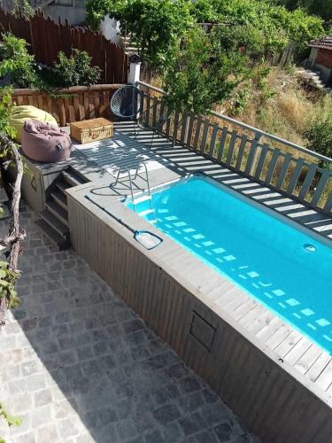 a small swimming pool in a backyard with a fence at Namaste къща в село Камилски дол in Kamilski Dol