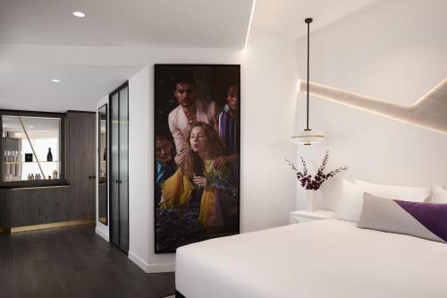 a bedroom with a large painting on the wall at Hotel X Brisbane Fortitude Vly, Vignette Collection by IHG in Brisbane