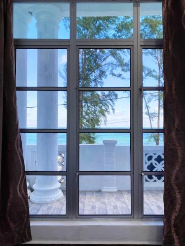 a window with a view of the water seen through it at Raihan Beach Resort in Dungun