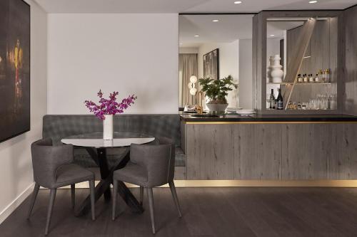 a dining room with a table and chairs and a bar at Hotel X Brisbane Fortitude Vly, Vignette Collection by IHG in Brisbane