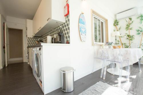 a kitchen and dining room with a washer and dryer at Beachome4u in Carcavelos