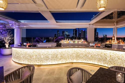 a bar with a view of the city at Hotel X Brisbane Fortitude Vly, Vignette Collection by IHG in Brisbane