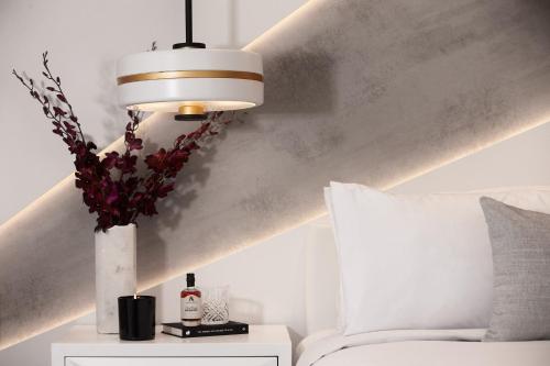 a room with a bed and a vase with flowers at Hotel X Brisbane Fortitude Vly, Vignette Collection by IHG in Brisbane