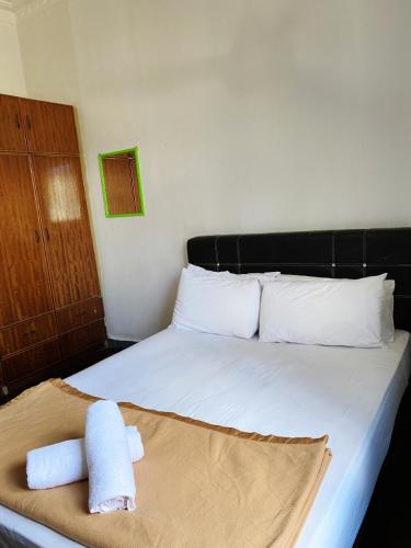 a bedroom with a bed with two towels on it at Raihan Beach Resort in Dungun
