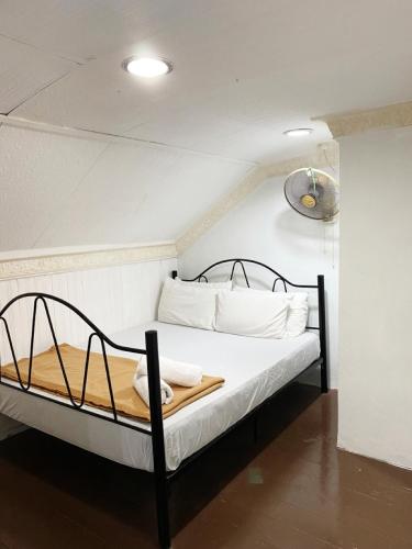 a bedroom with a bed with white sheets and pillows at Raihan Beach Resort in Dungun
