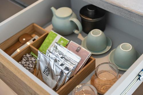 a drawer filled with dishes and glasses and a cupboard at WEAZER 西伊豆 in Izu