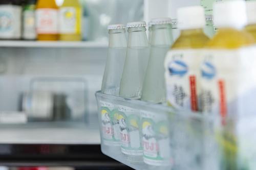a plastic container with bottles of drinks in a store at WEAZER 西伊豆 in Izu