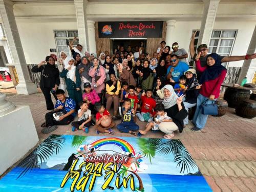 a group of people posing for a picture at a party at Raihan Beach Resort in Dungun