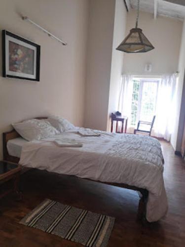 Postel nebo postele na pokoji v ubytování Dew Drops Cottage Coonoor By Lexstays