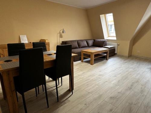 a living room with a table and a couch at Apartamenty ALICJA in Dzierżoniów