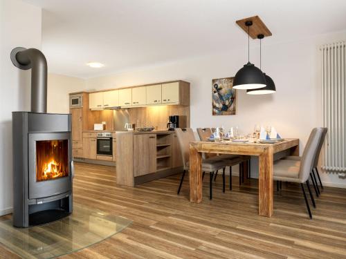 a kitchen and dining room with a fireplace at Haus Südwester Herzmuschel in Timmendorf