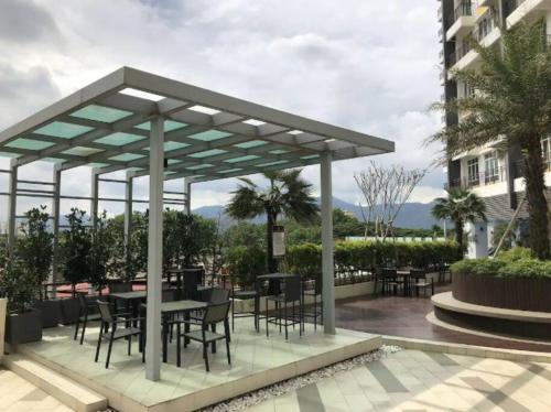 a pavilion with tables and chairs on a patio at IPOH CITY CENTRE Majestic Homestay Pool View 3 mins Walking to Famous Food Places & 15mins to Old Town Ipoh by Happy Homestay in Ipoh