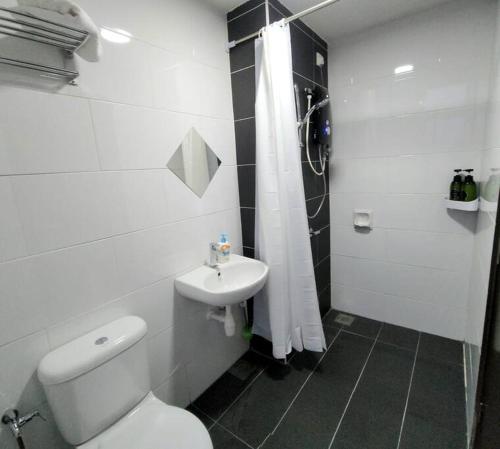 a white bathroom with a toilet and a sink at IPOH CITY CENTRE Majestic Homestay Pool View 3 mins Walking to Famous Food Places & 15mins to Old Town Ipoh by Happy Homestay in Ipoh